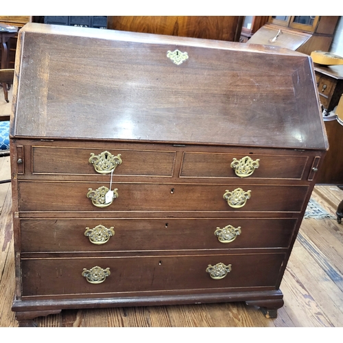 69 - A George III mahogany bureau, having two short and three long drawers, brass handles, supported on b... 