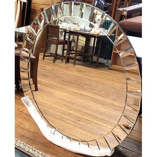 70 - A modern bevelled circular wall mirror 110cm