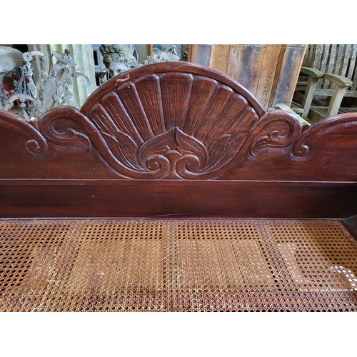 16 - A William IV window seat, with carved back and legs, rattan seat. 90cm x 200cm x 68cm