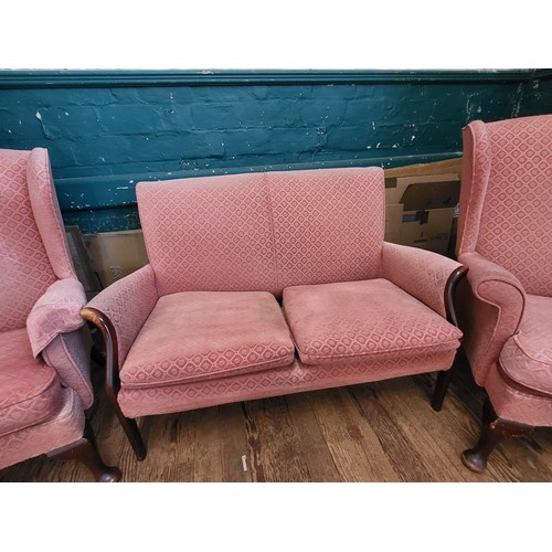 40 - A pink Parker Knoll upholstered sofa (87cm x 120cm x 64cm) and a pair of wingback chairs (96cm x 74c... 