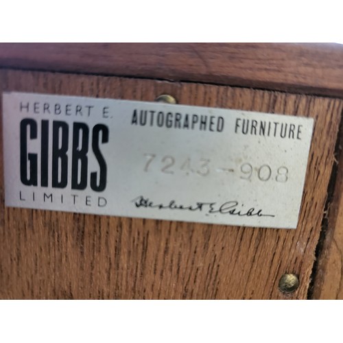 41 - A mid-century cabinet with glass sliding doors and shelf by Herbert E Gibbs. 112cm x 92cm x 28cm.