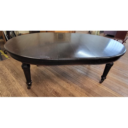 58 - A Victorian table on casters with one matching extra leaf  and a spare non matching leaf (61cm x 121... 