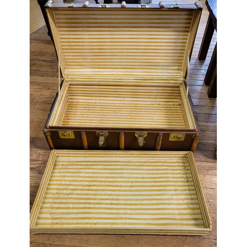 64 - A vintage trunk with yellow striped lining and lift out compartment. 33cm x 91cm x 53cm.