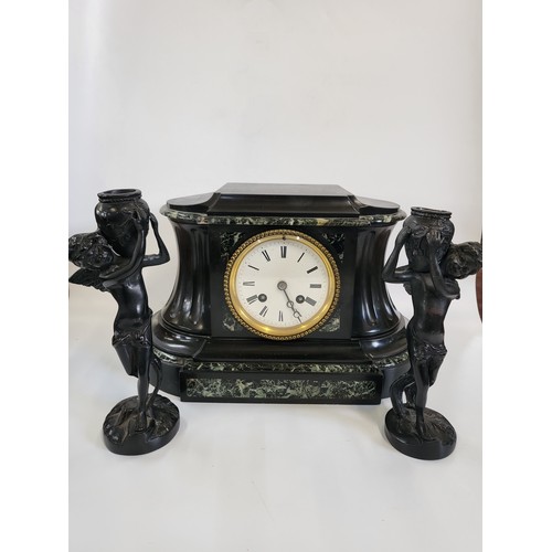 72 - A black marble clock and candlesticks