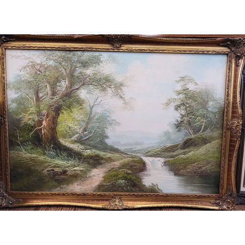 95 - Oil on canvas landscape with stream and trees. Framed in a decorative gilt frame. 71cm x 103cm.