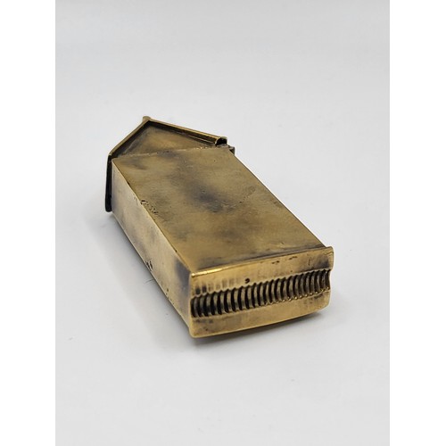 107 - A brass cased vesta case in the form of a century box with enamel plaque. 35g. 6cm x 2.5cm x 1cm.