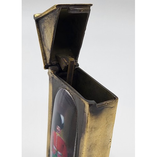 107 - A brass cased vesta case in the form of a century box with enamel plaque. 35g. 6cm x 2.5cm x 1cm.