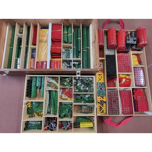 124 - Meccano part and components including red, green, and yellow tinplate sections canisters and strips ... 