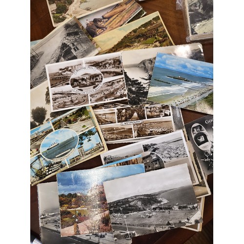 149 - Four packets of numerous postcards of seaside scenes and humorous cartoons.