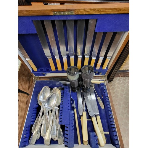 220 - A canteen of silver plate cutlery and a pair of binoculars.