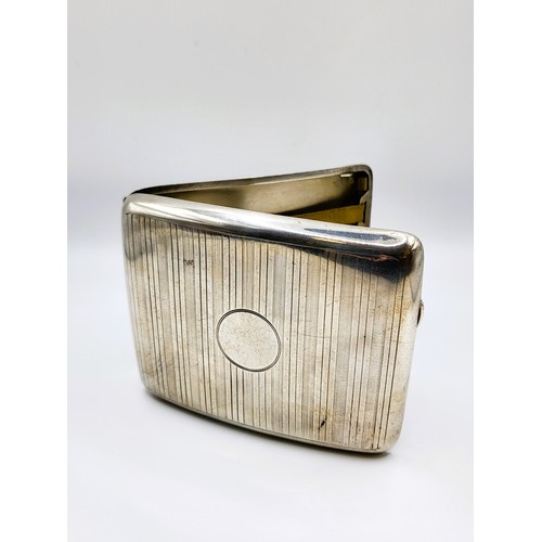 226 - A curved cigarette case, 1918. Machine turned, heavy weight. Birmingham (A & J Zimmerman) 11cm x 9cm... 