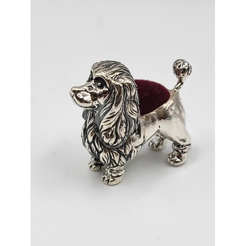 232 - A silver poodle dog pin cushion. 2.5cm x 3cm. 13g.