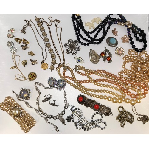 248 - A collection of costume jewellery including metal brooches, a sterling silver and enamel brooch, a b... 