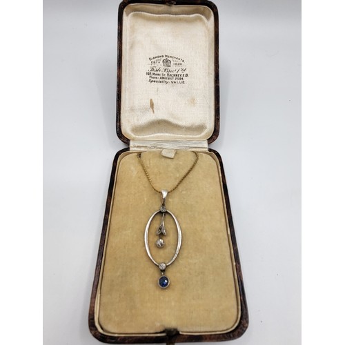 265 - An Edwardian necklace with three diamonds and a sapphire