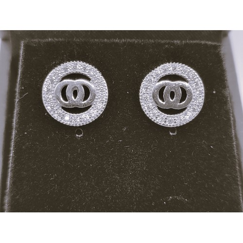 270 - A pair of silver and cubic zirconia designer style stud earrings. 1cm.