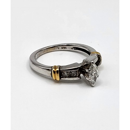 271 - A 14k mixed gold ring set with central Marquise cut diamond approx 1/2 ct. with four round brilliant... 