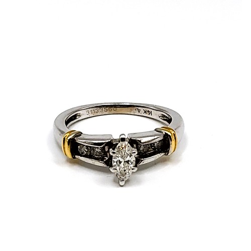 271 - A 14k mixed gold ring set with central Marquise cut diamond approx 1/2 ct. with four round brilliant... 