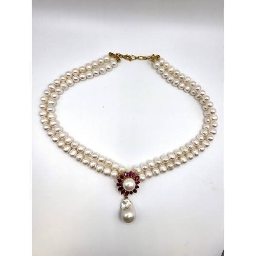 275 - An impressive fresh water pearl double row necklace with ruby clasp 46cm