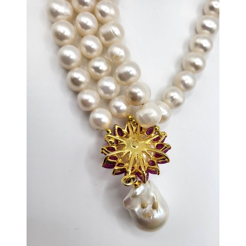 275 - An impressive fresh water pearl double row necklace with ruby clasp 46cm