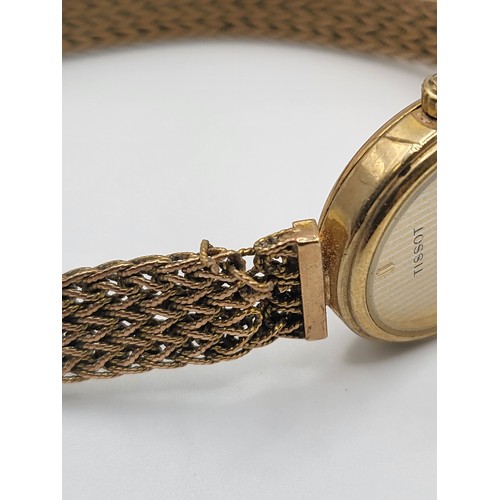 290 - Ladies Tissot 9ct Gold Quartz watch on a 9ct gold chainmail bracelet. 18g.