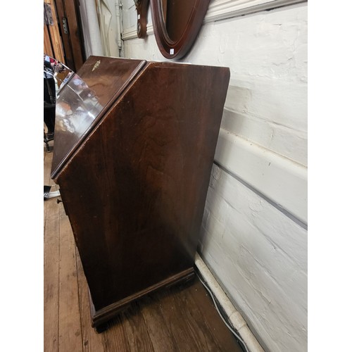 69 - A George III mahogany bureau, having two short and three long drawers, brass handles, supported on b... 