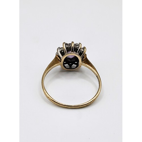 234 - 9ct yellow gold ring (hallmarked) with oval gemstone (tests as morganite) and paste surround. Size M