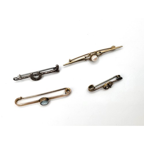 238 - Four pins including 9ct gold pin 5.2mm pearl, rose gold (unmarked) tie pin with oval cut blue paste,... 