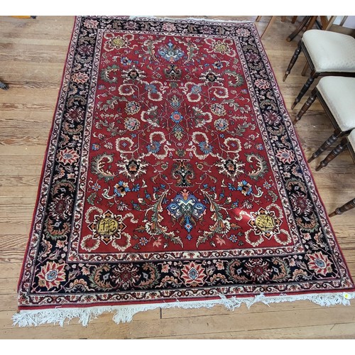 51 - Large red patterned rug. 300cm x 200cm.