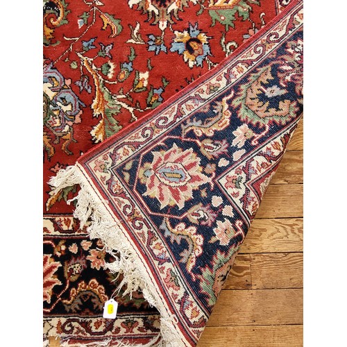 51 - Large red patterned rug. 300cm x 200cm.