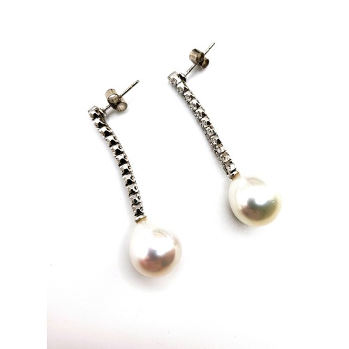 225 - A pair of 18ct white gold diamond set and Southern Seas pearl drop earrings (with paperwork and orig... 