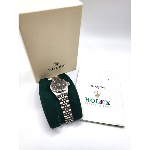 295 - A ladies Rolex Oyster perpetual date, stainless steel automatic with original purchase guarantee in ... 