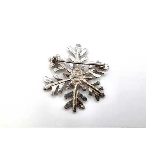 247 - A Norwegian silver snowflake shaped brooch, 3.5cm 9.6gms and an oval bark effect brooch in silver, 3... 