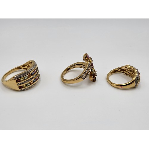 258 - Three gold on silver multi-gem set rings including a double channel set, princess cut, size S 5.2gms... 