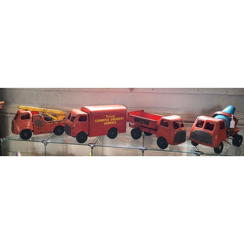 112 - Four Triang red painted steel trucks. (4)