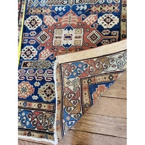 55 - Red and blue patterned handmade Turkish rug with original receipt. 155cm x 90cm.