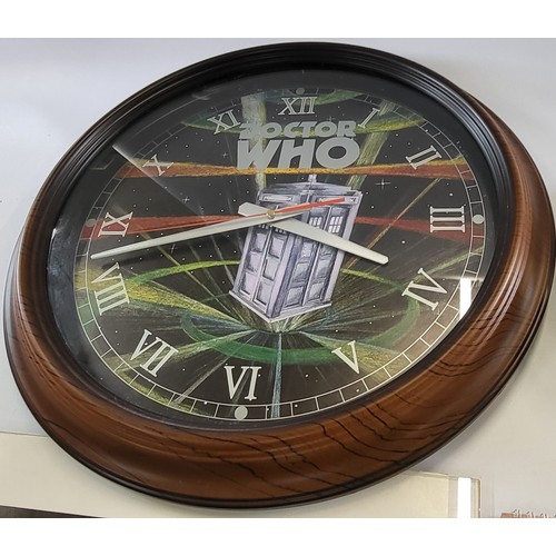 121 - Two Dr Who clocks (one with a wooden frame, the other with a chrome frame), A David Tennant calendar... 