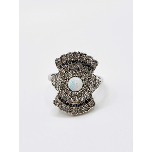 260 - A 925 silver cubic zirconia and man-made opal panelled Art Deco style dress ring. 4.9gms. Size R