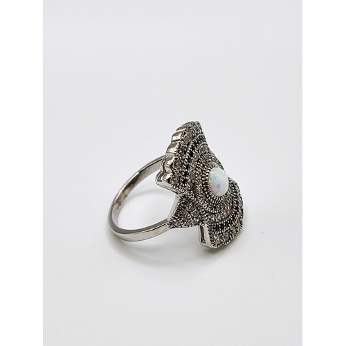 260 - A 925 silver cubic zirconia and man-made opal panelled Art Deco style dress ring. 4.9gms. Size R