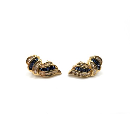 261 - A pair of 18ct yellow gold white sapphire and blue stone earrings, baguette and tapered baguette cut... 