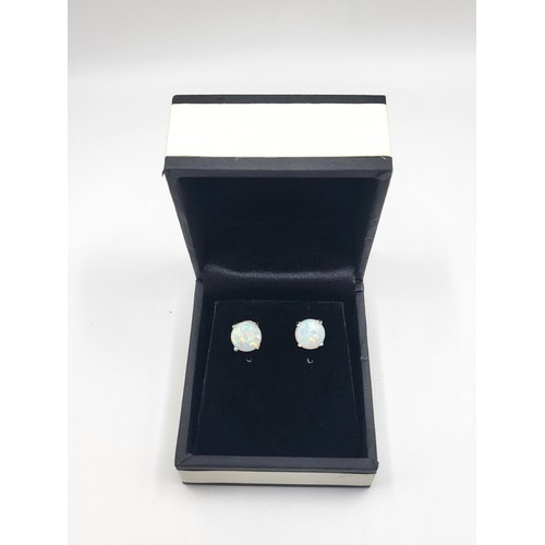 273 - A pair of silver and cubic zirconia and man-made opals stud earrings on silver posts 1.5cm x 1.1cm  ... 