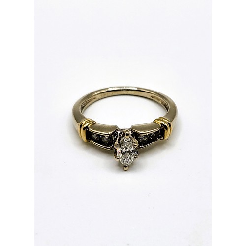 274 - A 14ct mixed gold and diamond ring set with a central marquise cut diamond of approx.  21pts plus fo... 