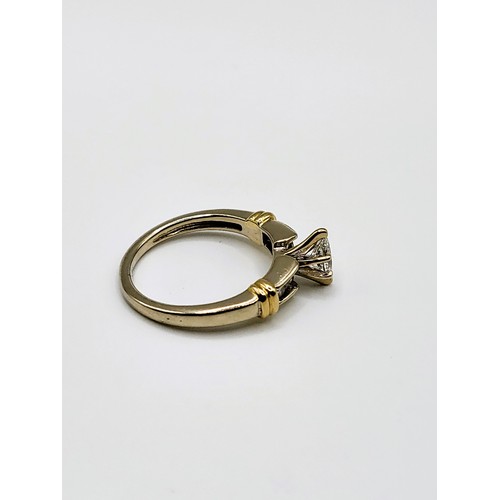 274 - A 14ct mixed gold and diamond ring set with a central marquise cut diamond of approx.  21pts plus fo... 