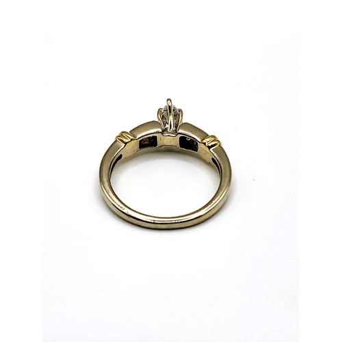 274 - A 14ct mixed gold and diamond ring set with a central marquise cut diamond of approx.  21pts plus fo... 