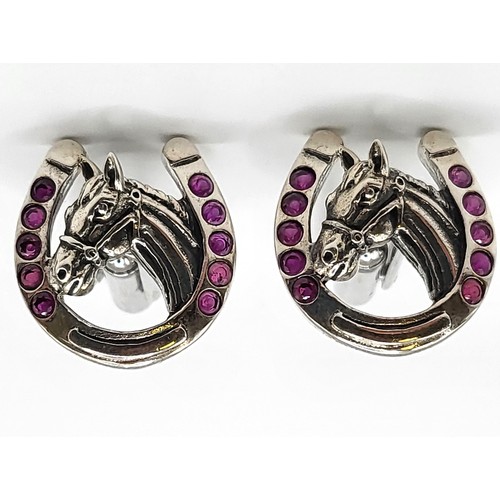 275 - A pair of silver and synthetic ruby set horseshoe shape cufflinks. 2cm x 1.7cm 10gms