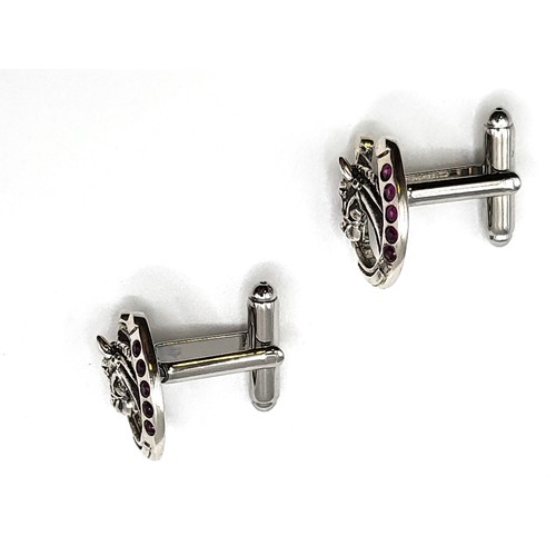 275 - A pair of silver and synthetic ruby set horseshoe shape cufflinks. 2cm x 1.7cm 10gms