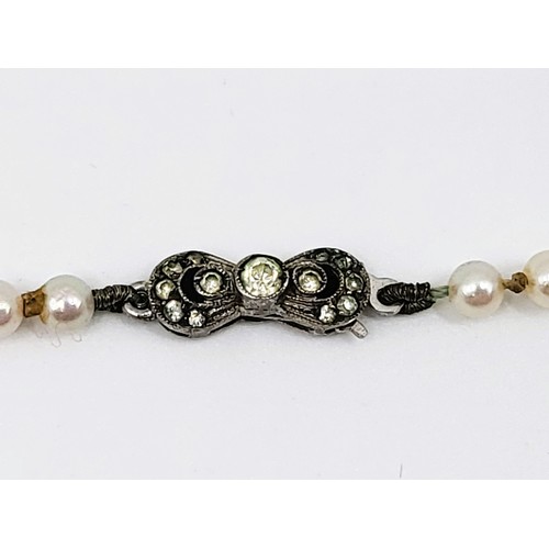 277 - A graduated set of cultured pearls with a silver (foreign) clasp measuring 53cm