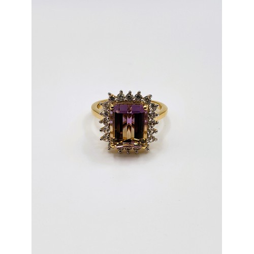 279 - An Ametrine ring emerald cut stone surrounded by round brilliant cut tourmaline on a gold coloured p... 