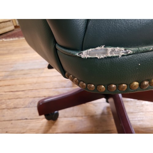 6 - A green faux leather button-back swivel office chair, supported on a pedestal base on casters