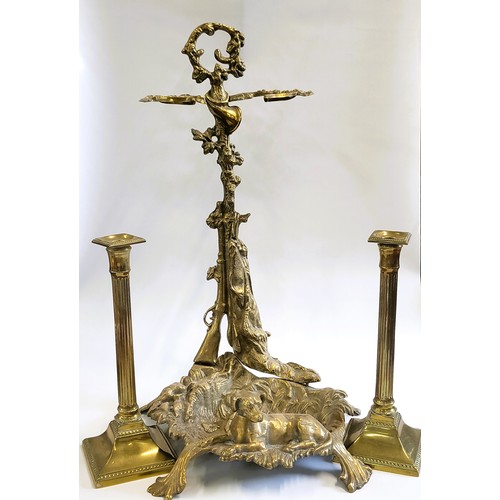 117 - A brass umbrella stand and two brass candlesticks