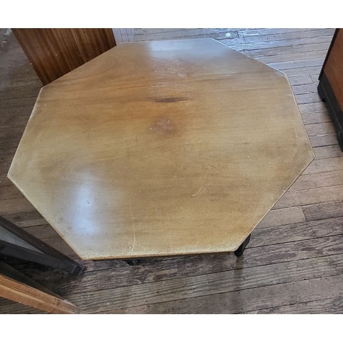 31 - Edwardian octagonal centre table with low shelf over cross stretcher and on castors. 70cm x 90cm x 9... 